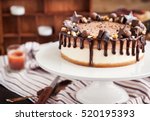 Small photo of Delicious two-ply chocolate cheesecake decorated with candies and frosting