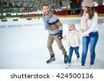 Smiling family at ice skating...