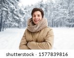 Hello, Winter. Attractive Man Smiling At Camera Posing Crossing Hands Standing In Snowy Forest.