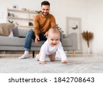 Happy Young Father Playing With Baby Toddler Having Paternity Leave, Bonding With Little Daughter At Home. Child Care, Cute Fatherhood Moments, Parenting Happiness. Selective Focus