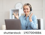 Small photo of Millennial teacher giving online lesson on webcam from home, blogger broadcasting on air. Young tutor in headphones participating in educational or business web conference on laptop