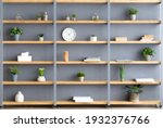 Parlor, office and simple home interior. Shelves with plants in pots, accessories, decor elements and clock on gray wall background in contemporary interior at flat, flat lay, copy space, nobody
