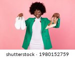 Shoes Fashion Choice. African American Shopaholic Woman Choosing Trendy Footwear Over Pink Studio Background. Female Chooses Between Sneakers And High Heels. Shopping Concept