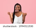 Small photo of Excited black woman in summer dress gesturing YES on pink studio background. Lovely African American lady celebrating success or achievement, feeling excited and triumphant