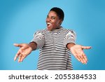 Small photo of Come Here. Excited Overweight African American Woman Shouting Stretching Hands Looking At Camera Posing Over Blue Background In Studio. Give Me A Hug Concept
