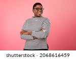 Happy Plus Size Black Woman Wearing Eyeglasses Smiling To Camera Standing Over Pink Background. Cheerful Millennial Female In Eyewear Posing In Studio