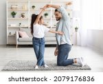 Small photo of Loving arabic father dancing with his adorable little daughter at home, happy dad teaching pretty long-haired female kid dancing waltz, single father spending weekend with his child, copy space