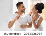 Small photo of Happy Young Arab Spouses Having Fun While Brushing Teeth In Bathroom Together, Portrait Of Happy Middle Eastern Couple With Toothbrushes In Hands Making Morning Dental Hygiene At Home, Closeup