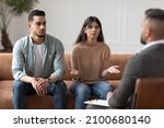 Small photo of Portrait of serious young lady talking to psychologist counselor complaining on bad relationship with husband, family couple counseling having conversation about problem at therapy session