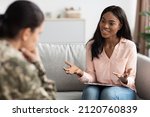 Small photo of Psychotherapy Concept. Black psychologist lady talking to soldier woman during individual therapy, professional african american therapist counseling depressed military female, selective focus