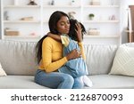 Small photo of Caring African American Mom Comforting Upset Little Daughter At Home, Worry Mom Soothing Crying Kid, Sad Black Female Child Embracing Mother, Feeling Parent Support And Protection, Copy Space
