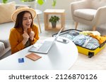 Small photo of Hot tour, special travel offer. Excited young woman booking tourist trip online on sale, getting discount on hotel reservation or plane tickets, planning vacation with laptop pc at home, copy space