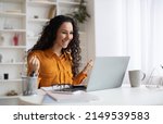 Small photo of Business Success. Happy Brunette Lady Using Laptop And Gesturing Yes Shaking Fists Celebrating Big Luck Working Online Sitting In Modern Office Indoor. Side View Shot