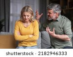 Small photo of Aggressive Behavior. Portrait Of Abusive Husband Shouting At Wife At Home, Angry Middle Aged Man Screaming At Spouse With Rage, Scared Depressed Woman Suffering Domestic Violence, Closeup