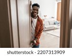 Small photo of Real Estate Offer. African American Male Opening Door Of His New House Smiling To Camera And Welcoming You To Apartment. Welcome To My Home. Property Purchase Concept