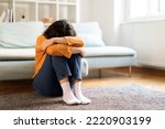 Depression Concept. Portrait Of Upset Young Middle Eastern Woman Crying At Home, Depressed Millennial Lady Burying Head In Knees While Sitting On Floor In Room, Suffering Mental Breakdown, Copy Space