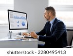 Small photo of Middle aged man financial analyst thinking on statistical information comparing data in charts graphs, accessing marketing strategy effectiveness, sitting at workplace in office