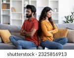 Young Indian Couple Sitting Back To Back On Couch At Home, Upset Eastern Man And Woman Offended After Domestic Quarrel, Suffering Family Conflicts And Problems In Relationship, Free Space