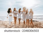 Small photo of Bride's team. Happy young multiracial women walking to camera, having fun at maiden evening near ocean, ladies embracing and smiling, full length