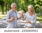 Small photo of Older Couple Conflicts. Mature Spouses Arguing While Walking In Park, Angry Senior Man And Woman Quarreling Outdoors, Suffering Misunderstanding And Marital Crisis, Wife Making Stop Gesture With Hand