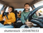 We are going on vacation. Happy family of three driving in their automobile, dancing to music and singing favorite song, enjoying travelling by car