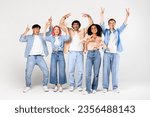 Small photo of Portrait of happy diverse friends showing various non verbal body language hand gestures and smiling at camera, standing against white studio wall background, full length