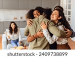 Small photo of Group of diverse young friends sharing hug during home party gathering at modern apartment interior. Fellow students, men and women, embracing united in laughter and friendship on weekend
