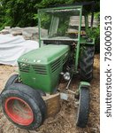 Small photo of Scena, Italy - July 07, 2016: Old Tractor next to a forest road in the forest near Derm village Shena.