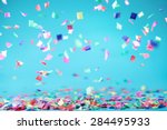 Colored confetti flying on blue ...