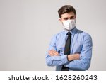 Small photo of is time to protect all the time. elegant man wearing a mouth protection to prevent getting sick at work or on the way to work