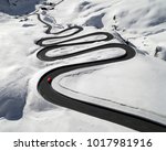 Aerial view of a red car traversing Julier Pass in the Swiss Alps