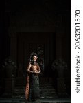 Small photo of Young female Actress wearing beautiful ancient costumes, in ancient monuments, dramatic style. Perform on legend love popular story, Thai Isan folktale called "Phadaeng and Nang-ai" in acient site