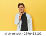 Small photo of Young Latino man posing on yellow background having a strong teeth pain, molar ache.