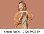 Small photo of Blonde middle-aged Caucasian woman in studio showing a timeout gesture.
