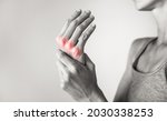 Small photo of Woman suffering from pain in hands and fingers, arthritis inflammation. Red highlight