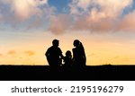 Silhouette of a family enjoying ...