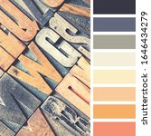 Small photo of A background of vintage letterpress blocks in a colour palette with complimentary colour swatches.