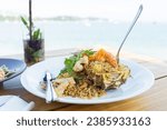 Small photo of Seafood fried rice in pineapple, appetizing in a cafe next to the sea, Sue Flamingo, Ao Yon Beach, Phuket Thailand