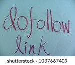 Small photo of Text dofollow link hand written by purple oil pastel on blue color paper