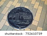 Small photo of KOBE, JAPAN-May 06, 2017: A manhole cover in Kobe, Japan. Kobe tower at Port of Kebe embossed on a manhole cover as a symbol of an important city's landmark. Drain cap japanese style on walkway in