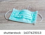 protective face mask on wood... | Shutterstock . vector #1637625013
