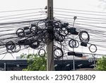 Small photo of Intertwined electric wires. A tangled electrical wires showcasing the complexities of the city's power supply system. telephone wires and wireless provider cables.