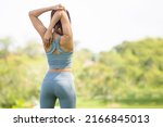 Back view of sport woman warming up outdoors, Fitness woman doing stretch exercise stretching her arms