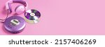 Small photo of Personal compact portable CD player disks purple headphones on a pink background.