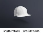Blank cap in perspective view. White snapback on dark background. Blank baseball snap back cap for your design. Mock up hat cap for you logo, brand identity etc.
