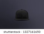 Blank cap front view. Black snapback on dark background. Blank baseball snap back cap for your design. Mock up hat cap for you logo, brand identity etc.