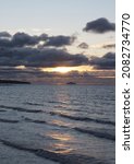 Small photo of Winter sun setting viewed from Prestwick beach with Alisa Criag in the background