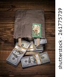 Small photo of Brown paper bag containing that moolah and Congratulation card. Bag full of money - vintage photography of brown paper bag with stacks of hundred dollar bills on wooden background