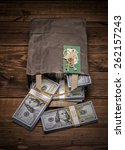 Small photo of Brown paper bag containing that moolah and Congratulation card. Bag full of money - vintage photography of brown paper bag with stacks of hundred dollar bills on wooden background