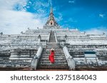 Small photo of Historical local travel Thai concept, Happy traveler asian woman with dress and straw hat sightseeing in Wat Phu Khao Thong temple with white pagoda at Ayutthaya historical park, Ayutthaya, Thailand
